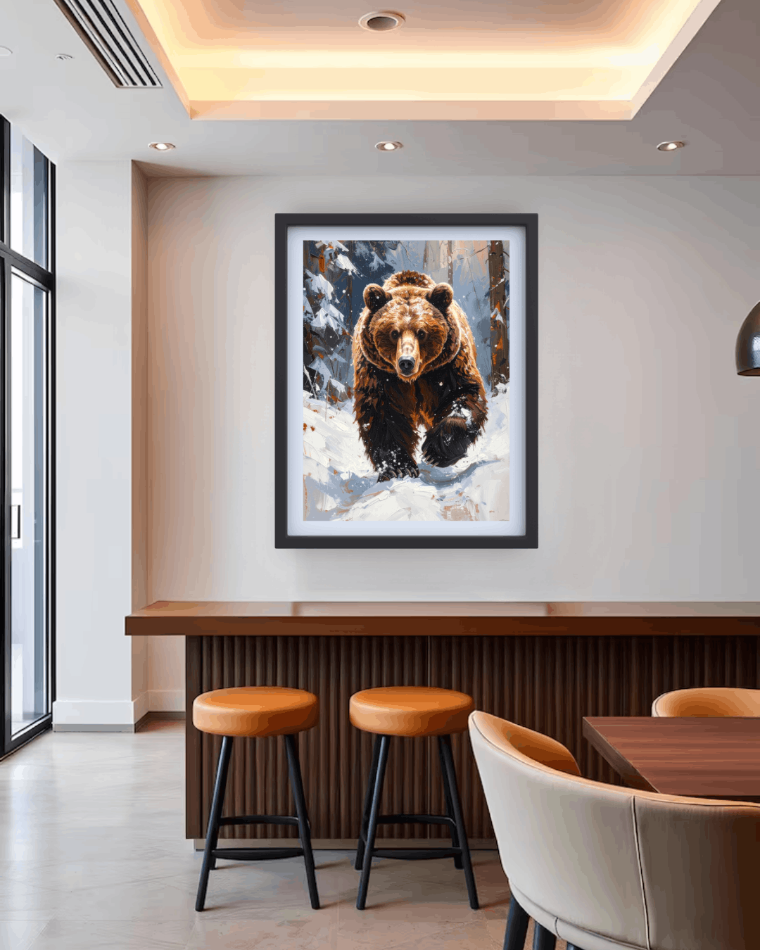 Framed picture of a bear in a snowy landscape hanging on a wall above a bar with stools and chairs.