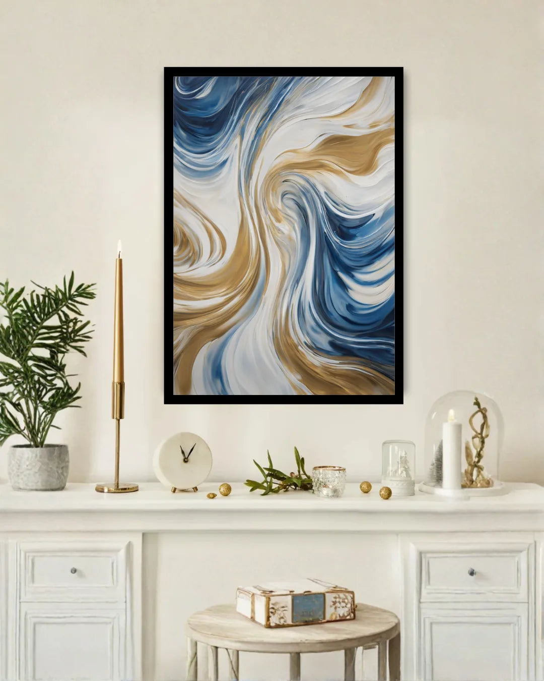 A framed abstract wall art print with swirling blue, white, and tan marbled patterns, displayed above a white console table in a styled interior setting.