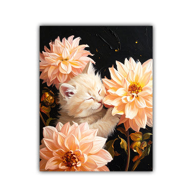 A vertical canvas art print featuring a sleeping cream-colored kitten nestled among large peach-pink dahlia flowers against a dark black background, shown as a mockup on a white wall.