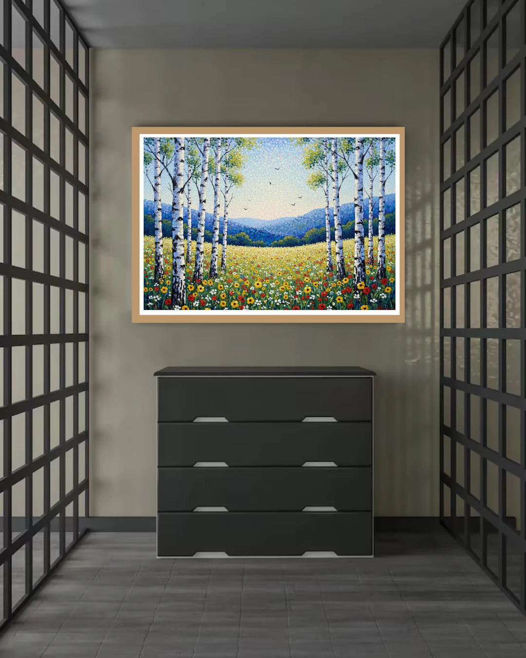 Framed landscape painting above a black dresser in a room with geometric wall patterns.