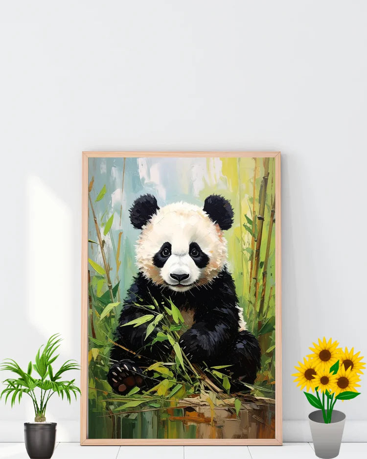 Framed artwork of a panda bear sitting among bamboo leaves on a white wall.
