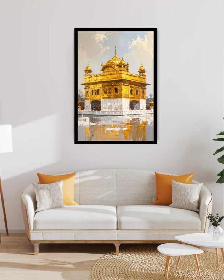 A framed art print of the Golden Temple in Amritsar, displayed on a light gray wall above a modern white sofa with orange and gray pillows in a styled living room setting.