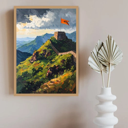 A framed landscape painting of the Great Wall on a green mountain ridge under a cloudy sky, displayed on a beige wall next to a white decorative vase with dried palm leaves.