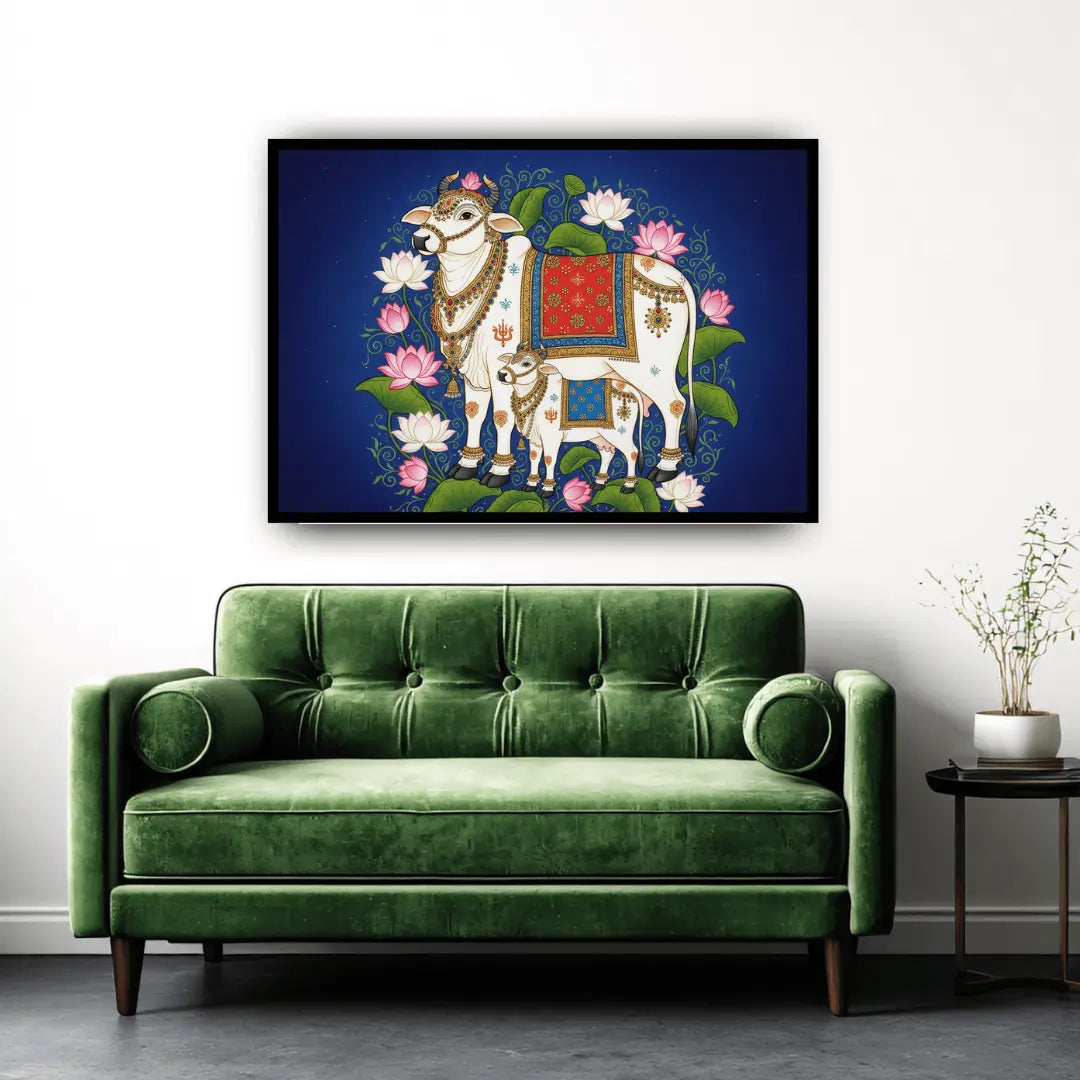 Green sofa in a room with a framed artwork of two cows and flowers on the wall.