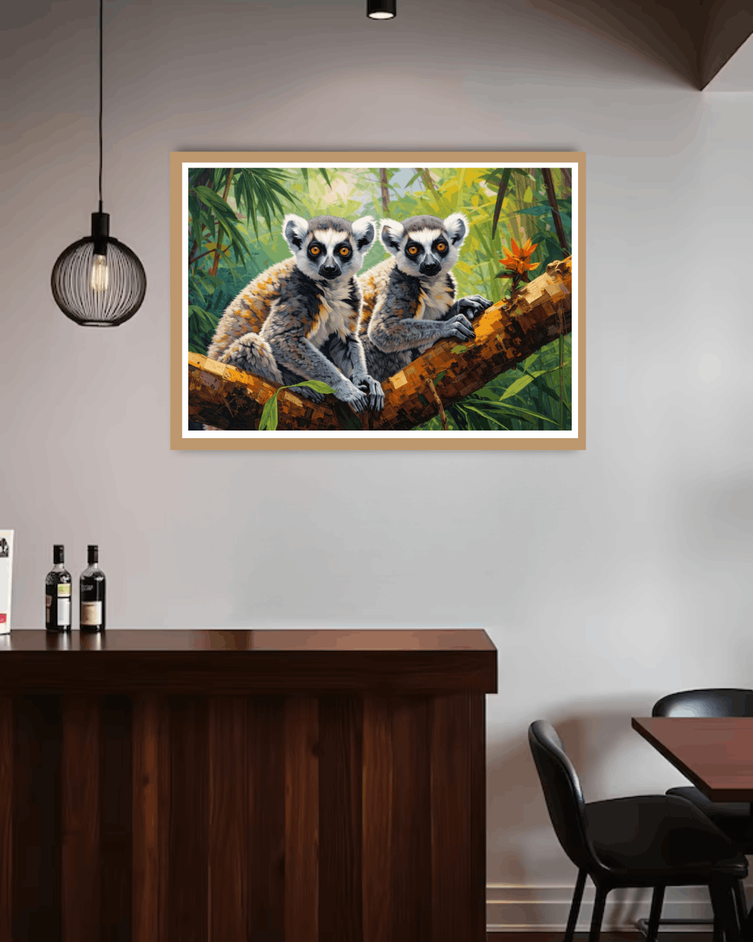 Framed artwork of two lemurs on a branch in a room with a wooden counter and chairs.