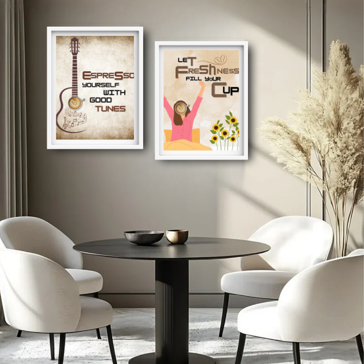 Two framed wall art prints hanging above a round black table with white chairs in a modern room. The left print shows an espresso-themed guitar illustration with the text &