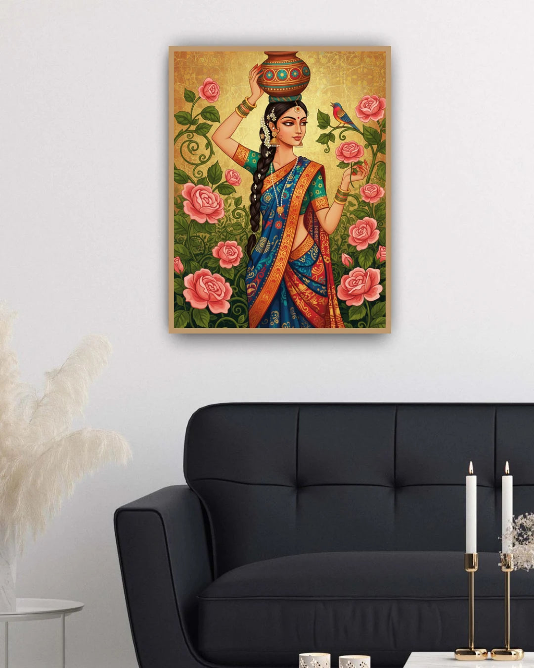 Framed artwork of a traditional Indian woman with flowers on a wall above a black sofa.