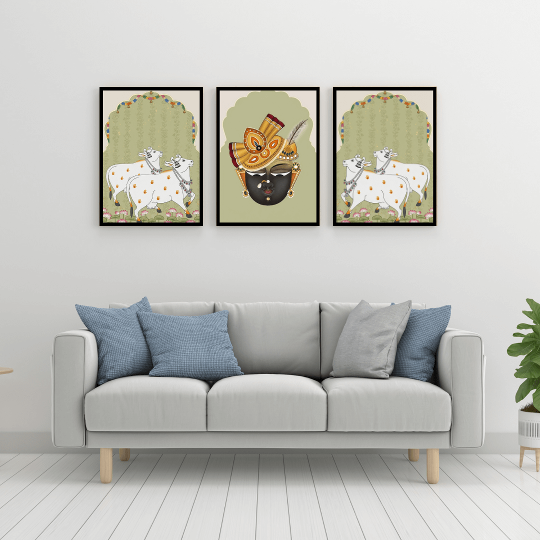 Gray sofa with blue and gray pillows in a room with framed artwork on the wall.