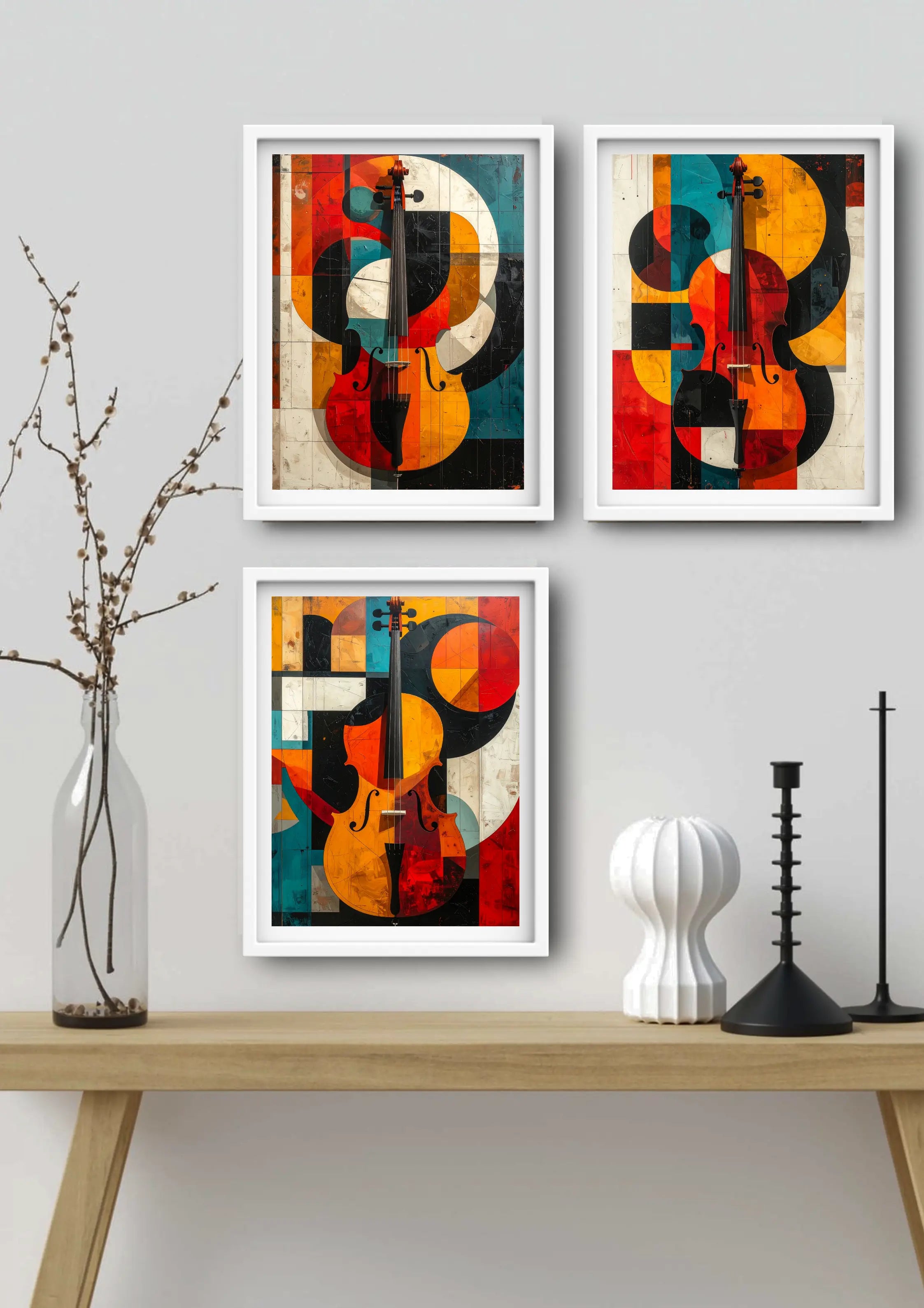 Three abstract art prints of on a wall above a wooden shelf with decorative items.