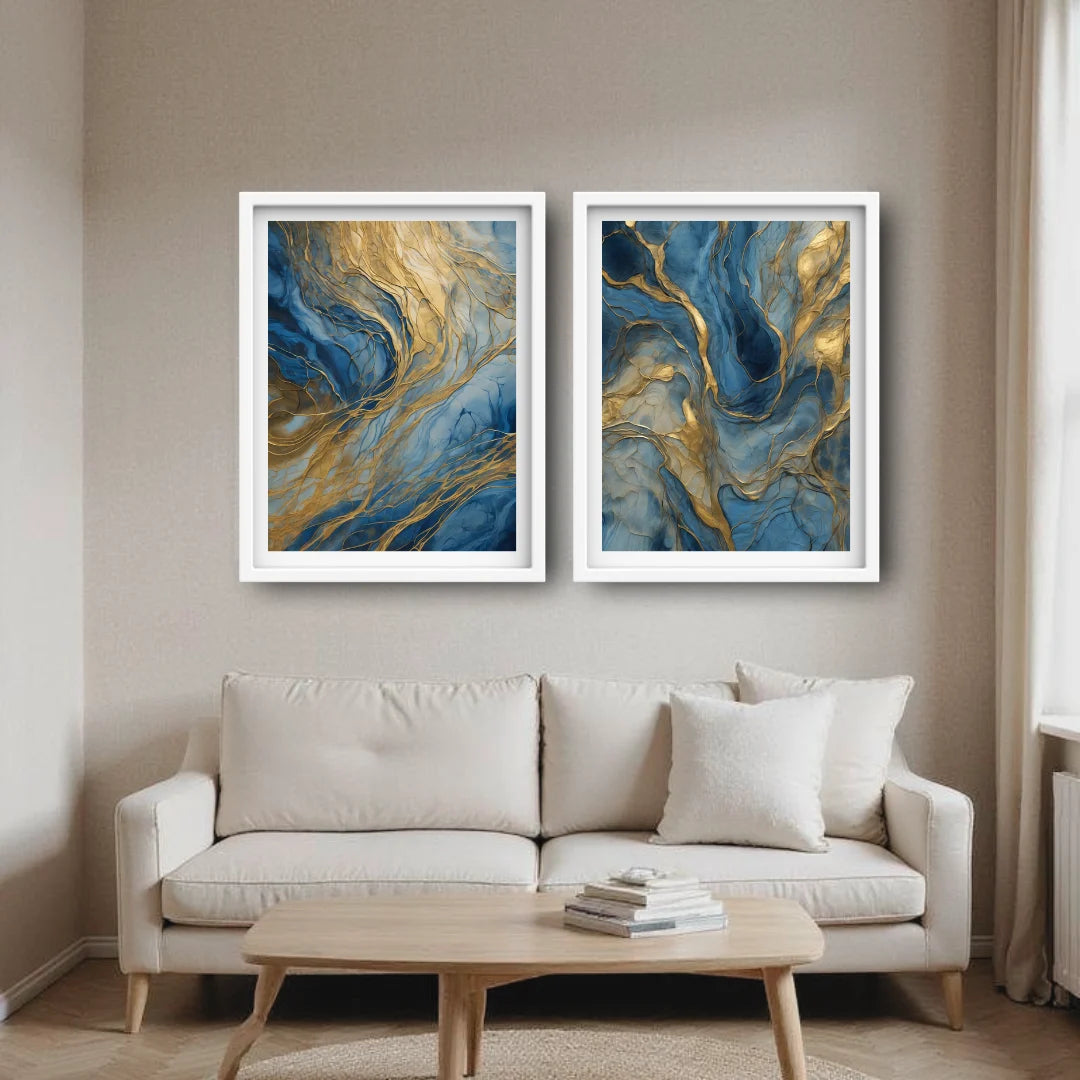 Two abstract paintings in white frames on a wall above a beige sofa with a wooden coffee table.