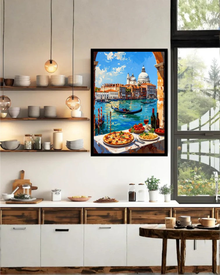 A framed colorful painting of a Venetian canal scene with gondolas, domes, and food on the table, displayed on a kitchen wall above a counter in a modern kitchen setting.