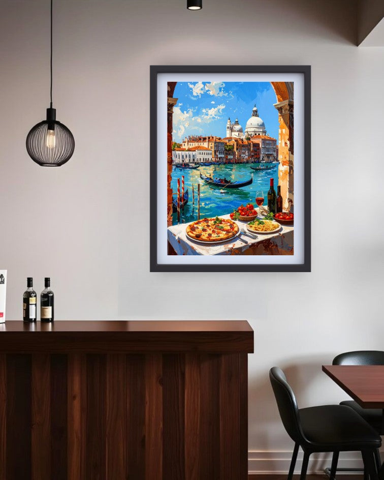 A framed art print depicting a colorful Venetian canal scene with gondolas, domes, and outdoor dining tables, displayed on a light gray wall above a dark wood counter in a modern interior setting.