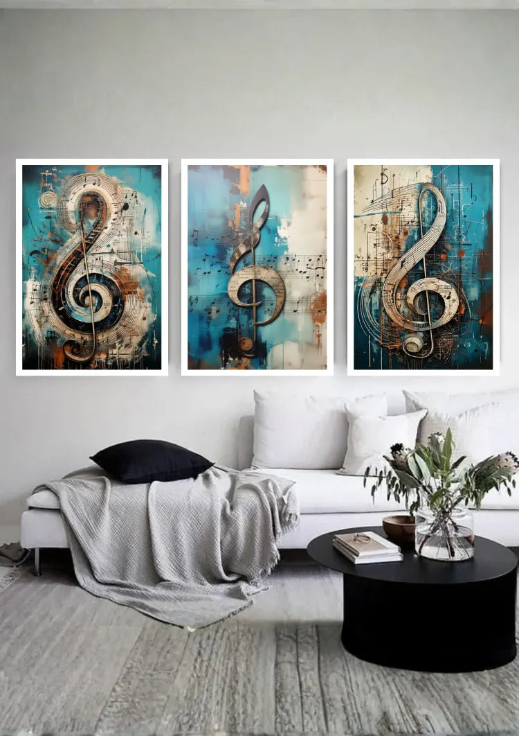 A three-panel framed wall art set featuring large abstract musical treble clefs in blue, teal, beige, and brown tones, displayed above a white sofa in a modern living room setting.