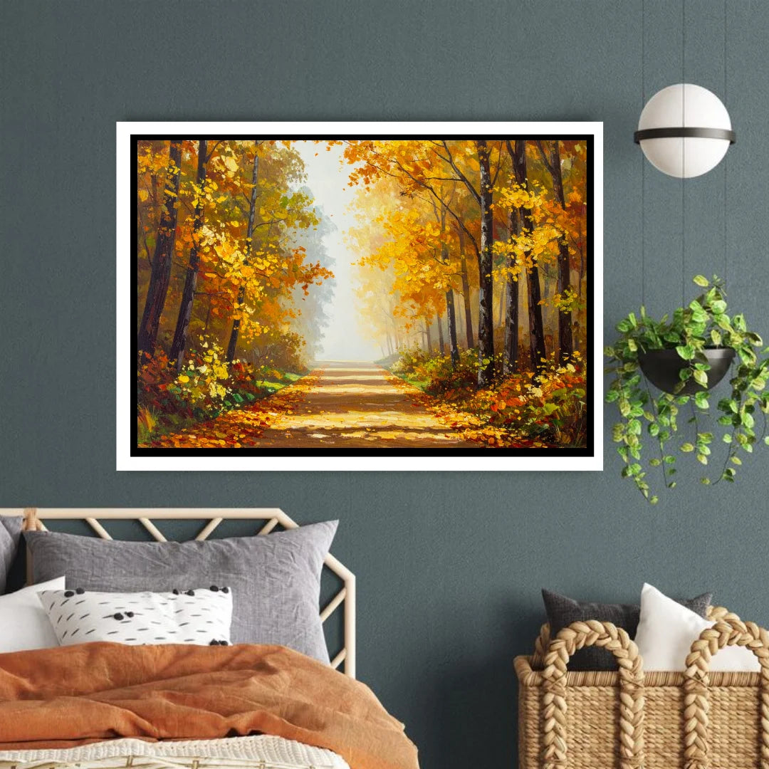 Framed painting of an autumn forest on a wall above a bed.