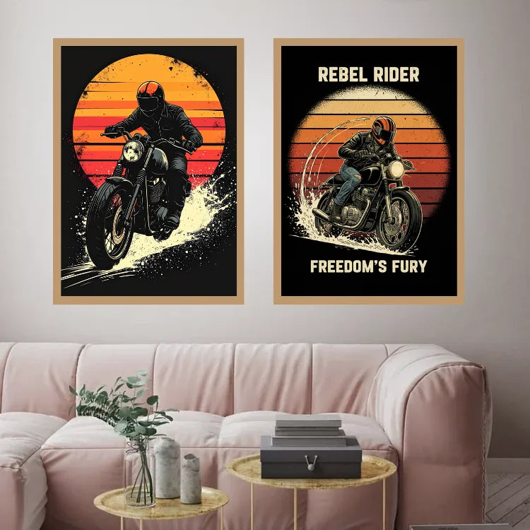 Two framed biker posters hanging on a light gray wall above a pink sofa. The left poster shows a motorcycle rider against a sunset, and the right poster reads &