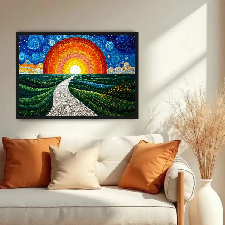 A framed colorful landscape painting hangs on a beige wall above a white sofa with orange and cream pillows. The artwork shows a winding road leading to a large orange and red sun over green rolling hills under a blue swirling sky.