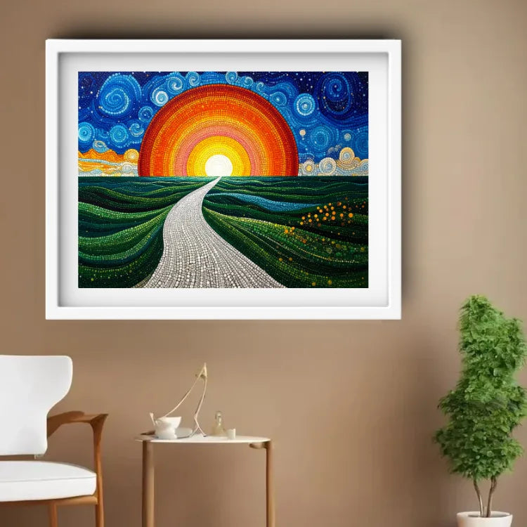 A framed colorful wall art print hangs on a beige wall above a small side table with a chair and a potted plant. The artwork shows a winding light-colored path through green rolling hills under a large glowing orange and yellow sun in a swirling blue sky.