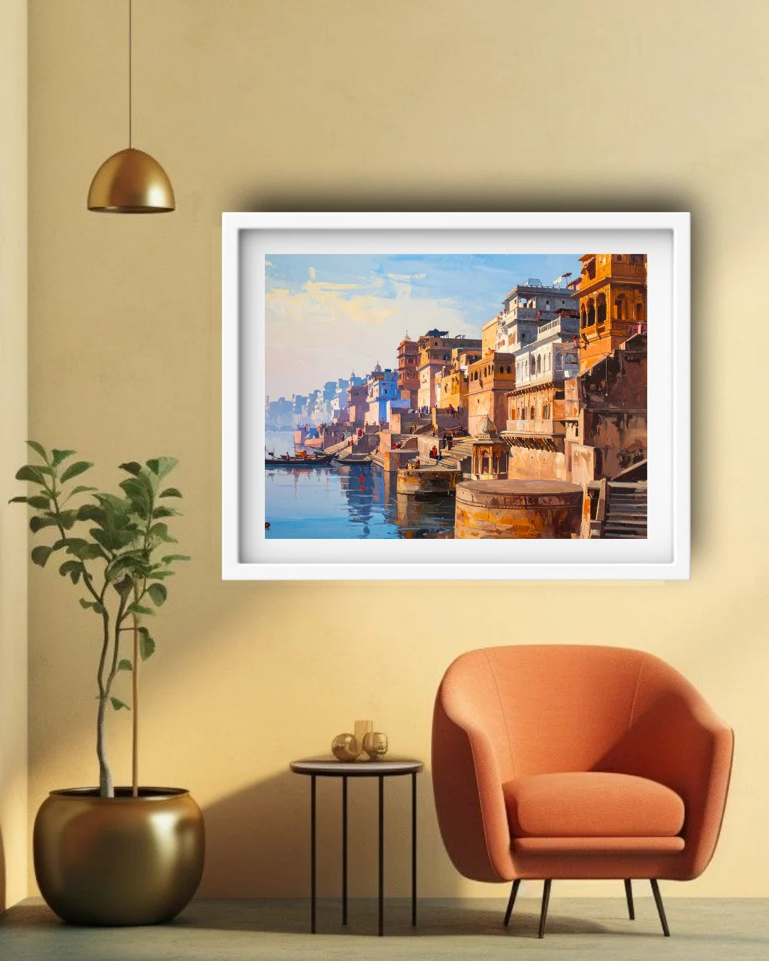 A framed art print depicting a colorful waterfront city scene with buildings and water, displayed on a beige wall above an orange armchair and next to a potted plant in a modern living room setting.