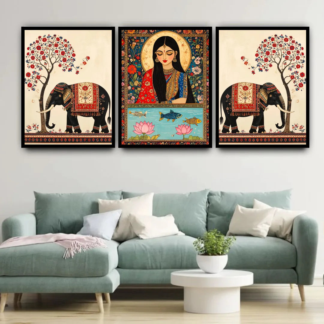 Three framed artworks on a wall above a sofa in a living room.