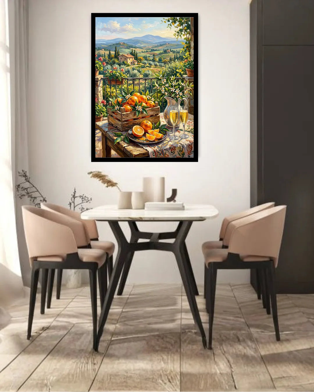 A framed vertical canvas print of a Tuscan landscape and fruit still life hangs on a white wall above a dining table with four chairs in a modern dining room setting.
