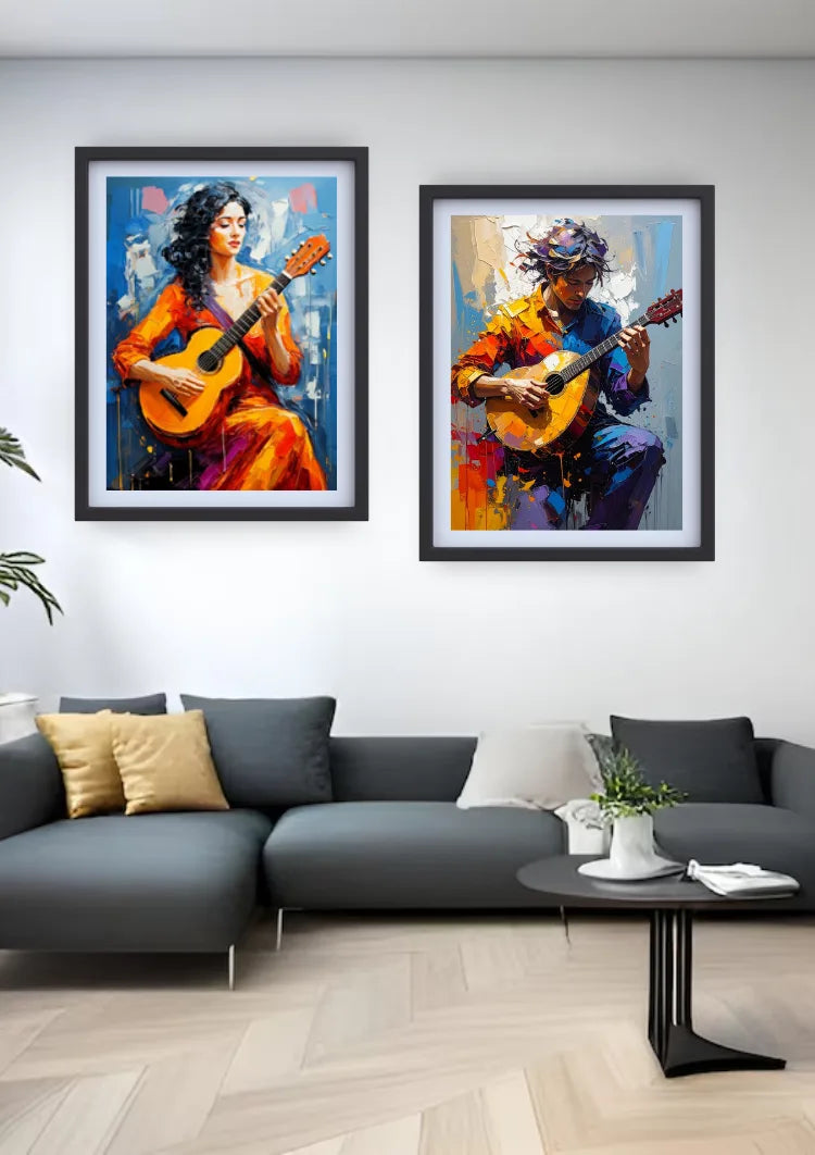 Two framed colorful paintings of guitar players hanging on a white wall above a dark gray sectional sofa in a modern living room.