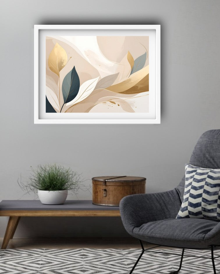 A framed abstract art print with flowing cream, beige, gold, and dark teal leaf-like shapes, displayed on a gray wall above a wooden console table in a modern living room setting.