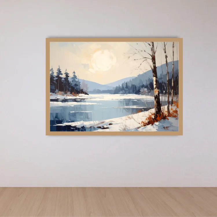 A framed landscape painting of a snowy winter lake scene with pine trees, bare birch trees, mountains, and a bright sun, displayed on a light gray wall above a light wood floor.