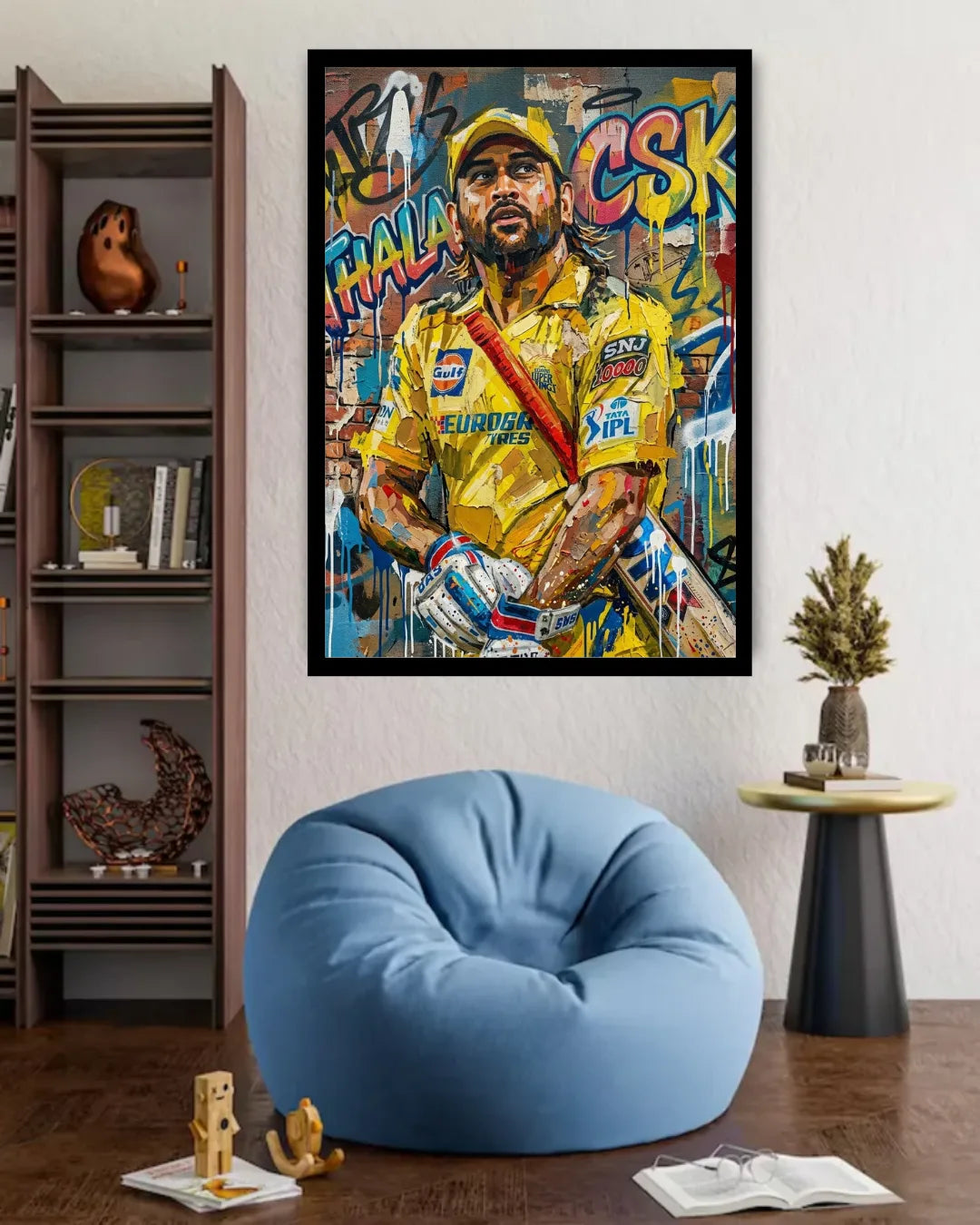 Framed artwork of a sports player in a yellow jersey on a wall above a blue bean bag chair.
