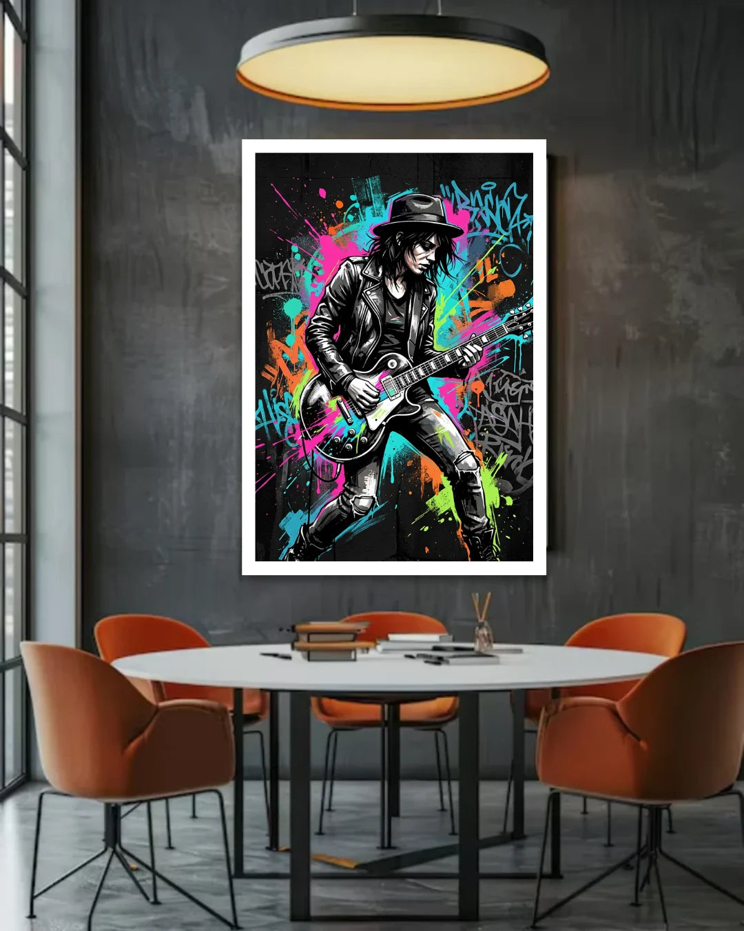 Framed poster of a musician playing guitar in a colorful setting above a dining table with orange chairs.