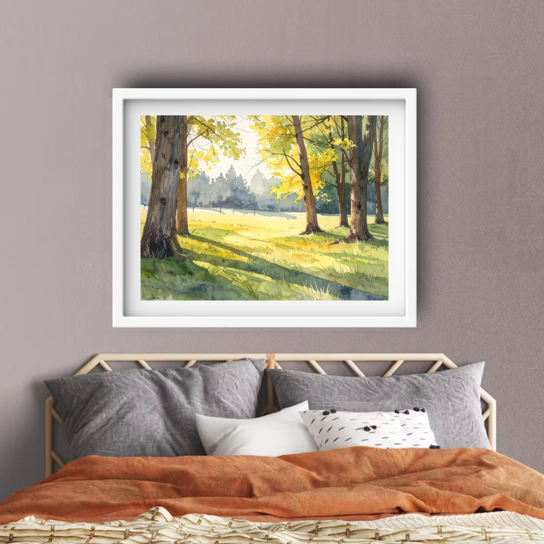 Framed artwork of a forest scene above a bed with a brown blanket and gray pillows.