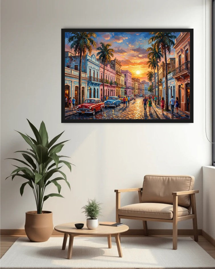 A framed colorful painting of a vintage street scene in Havana hangs on a white wall above a beige armchair, a small wooden coffee table with a plant, and a large potted plant.