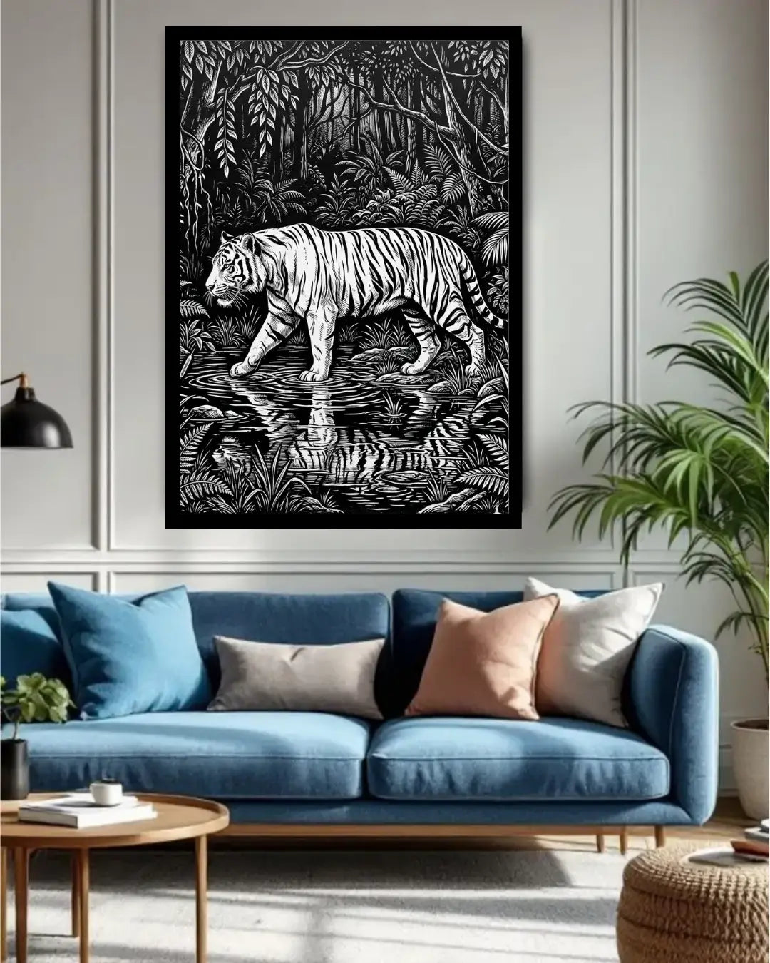 Living room with a blue sofa, decorative pillows, and a framed black and white tiger artwork on the wall.