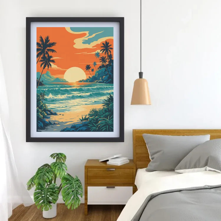 A framed tropical beach sunset print hangs on a white wall above a wooden nightstand and bed. The artwork shows palm trees, ocean waves, and a bright orange sky, while the room includes a plant, pendant light, and gray bedding.