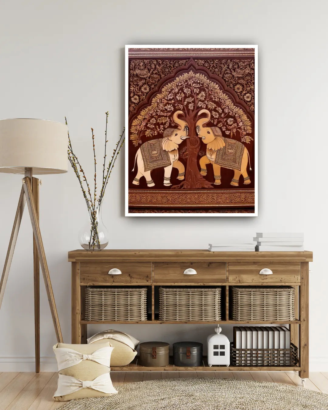 Framed artwork of two elephants under a tree on a wall above a wooden console table.