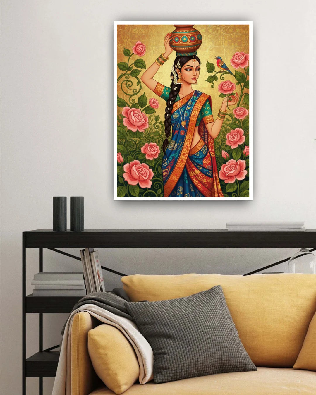 Framed artwork of a woman in a colorful saree with flowers and a bird, displayed above a yellow sofa.