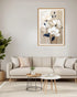 Framed floral artwork on a wall above a beige sofa in a living room.