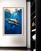 Framed artwork of a shark in an underwater scene on a wall next to a bookshelf.