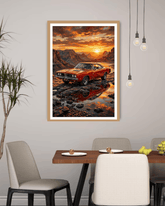 Framed artwork of a red car at sunset over water in a dining room.