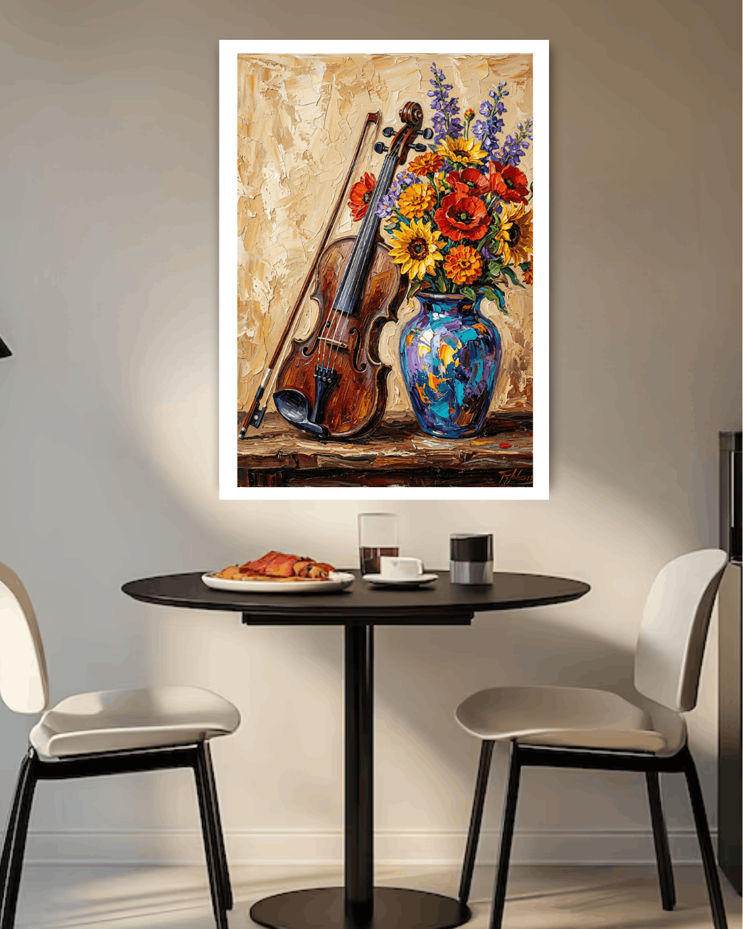 Framed painting of a violin and flowers on a wall above a table with chairs.