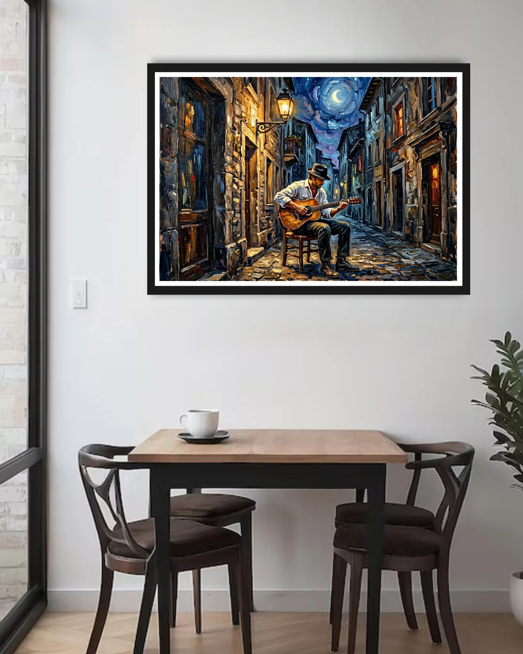 Framed artwork of a musician playing guitar on a city street at night, above a dining table.