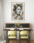 Dining room with a table and chairs, and a framed abstract art piece on the wall.