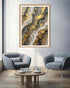 Modern living room with abstract art on the wall, two gray chairs, and a wooden coffee table.