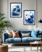 Blue sofa with decorative pillows in a living room setting with floral artwork on the wall.