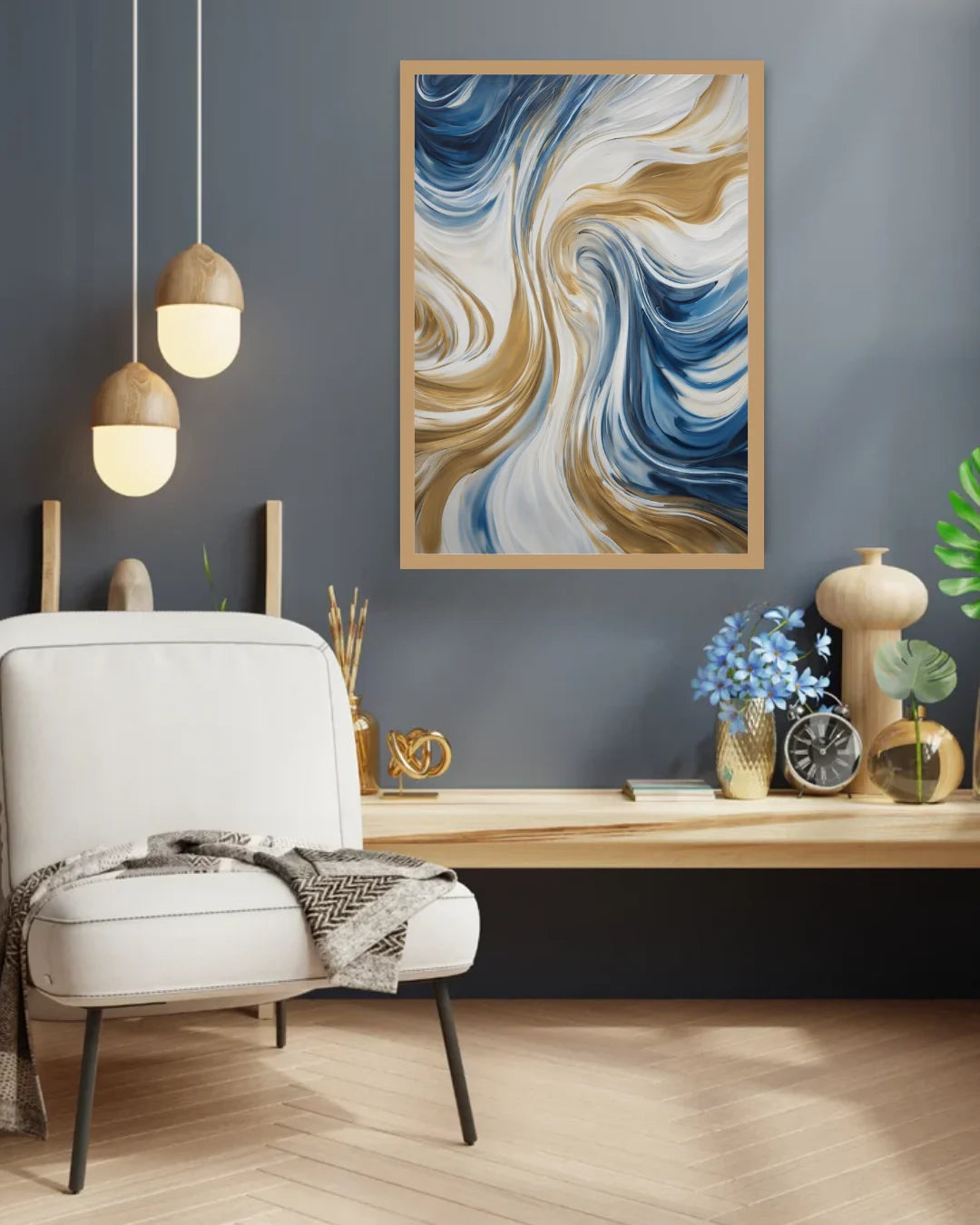 A framed abstract wall art print with swirling blue, white, and gold paint waves, displayed in a modern living room setting above a light wood console table and a white armchair.