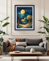 A framed art print depicting a whimsical forest scene under a full moon, displayed on a cream-colored wall above a modern gray sofa in a styled living room.