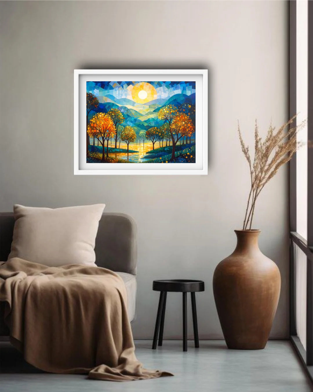Framed artwork of a sunset over trees in a living room setting with a vase and chair.
