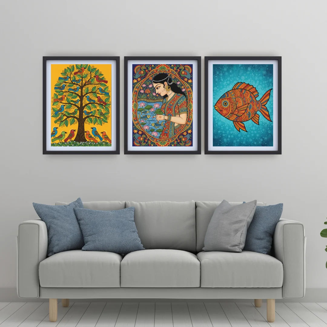 Three colorful framed artworks above a gray sofa with blue cushions.