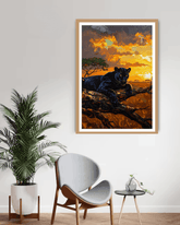Framed artwork of a panther on a branch with a sunset background in a living room setting.