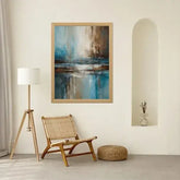 Blue and brown abstract canvas painting displayed in a minimalist living space with chair décor.