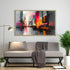 Colorful abstract cityscape canvas painting displayed above a modern grey sofa.